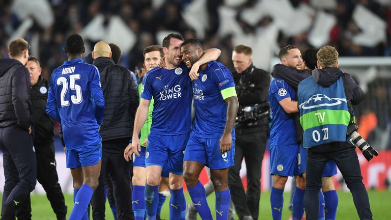 LEICESTER, ENGLAND - MARCH 14:  Christian Fuchs and Wes Morgan of Leicester City celebrate their team's 3-2 agg victory during the UEFA Champions League Ro