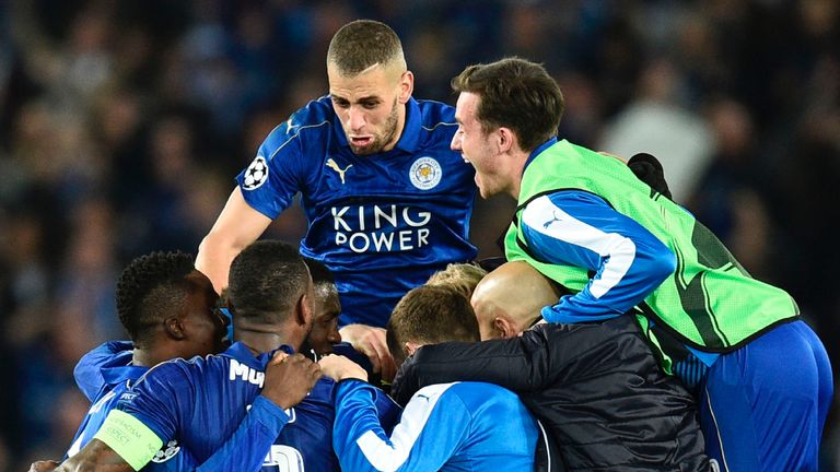 Leicester City's Algerian striker Islam Slimani (CL top) jumps in to celebrate with his Leicester teammates after their victory at the end of the UEFA Cham