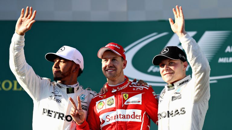 Sebastian Vettel celebrates his win on the podium with second placed Lewis Hamilton and third place Valteri Bottas