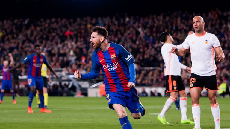 Lionel Messi celebrates his second goal against Valencia
