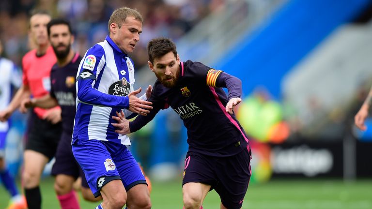 Lionel Messi takes on Alex Bergantinos (L) during Sunday's La Liga clash