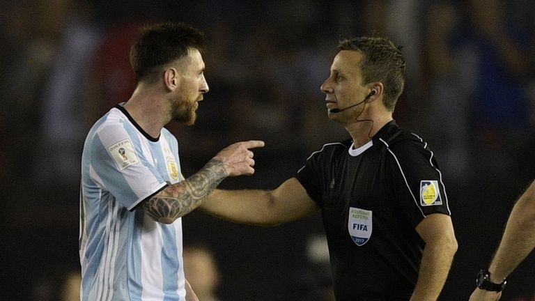 Argentina's forward Lionel Messi (L) argues with first assistant referee Emerson Augusto de Carvalho at the end of their 2018 FIFA World Cup Russia South A