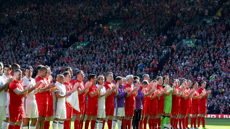 The two team's stand for a minute's applause in memory of Ronnie Moran during the charity match at Anfield, Liverpool.