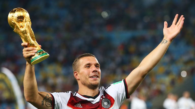RIO DE JANEIRO, BRAZIL - JULY 13:  Lukas Podolski of Germany celebrates with the World Cup trophy  after defeating Argentina 1-0 in extra time during the 2