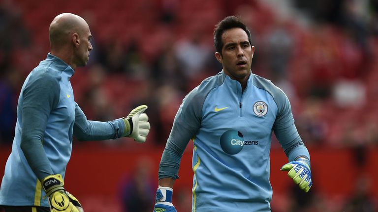 Manchester City's Claudio Bravo (R) warms up with fellow goalkeeper Willy Caballero (L) ahead of the Premier League clash with United, September 10 2016