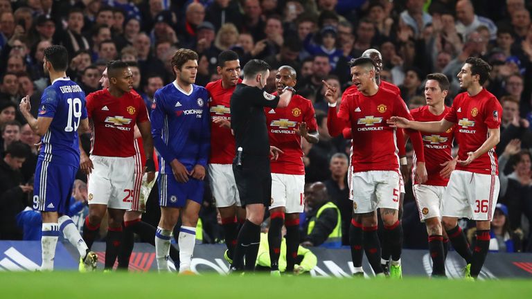 LONDON, ENGLAND - MARCH 13:  Manchester United players protest as Ander Herrera of Manchester United (2R) is shown a red card by referee Michael Oliver and