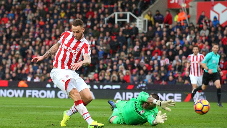 STOKE ON TRENT, ENGLAND - MARCH 04: Marko Arnautovic of Stoke City (L) scores his sides first goal past Victor Valdes of Middlesbrough (C) during the Premi