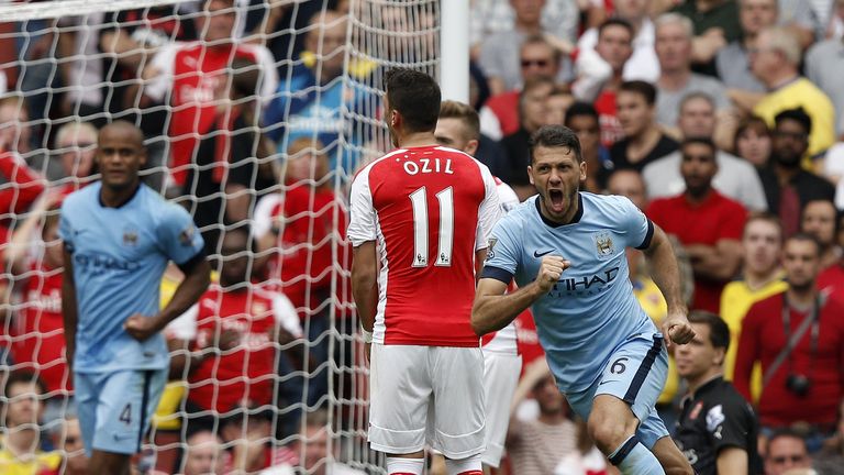 Manchester City's Argentinian defender Martin Demichelis (R) celebrates scoring a goal during the English Premier League football match between Arsenal and