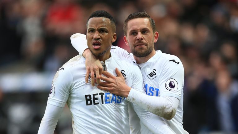 SWANSEA, WALES - MARCH 04: Martin Olsson of Swansea City (L) celebrates scoring his sides second goal with Gylfi Sigurdsson of Swansea City (R) during the 