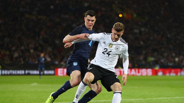 England's Michael Keane in action with Germany's Thomas Muller