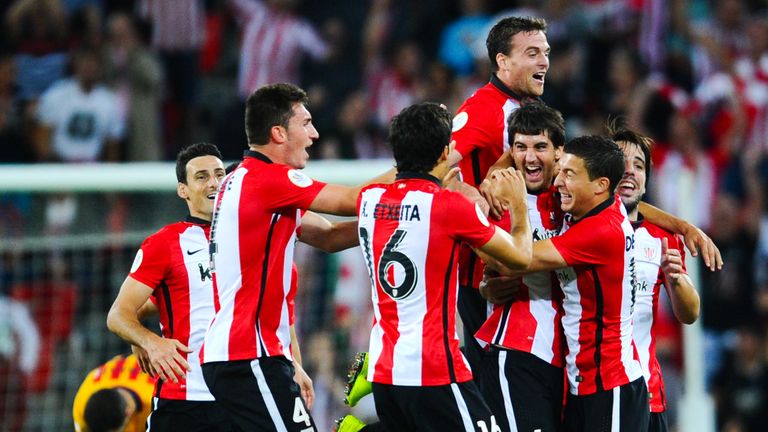 Mikel San Jose is mobbed by his team-mates after scoring against Barcelona 