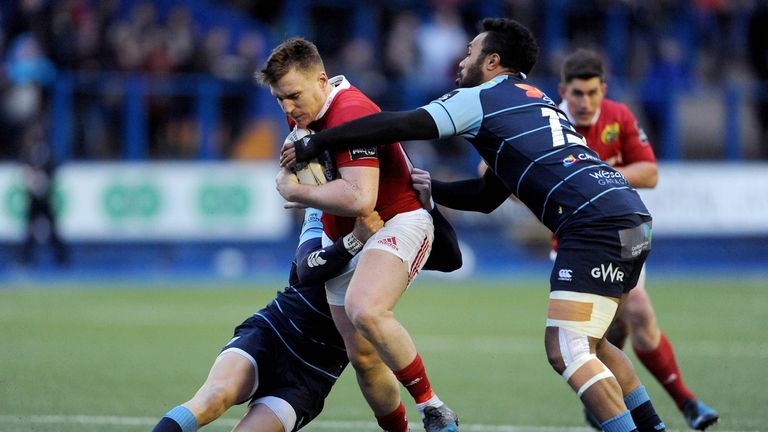 Munster's Rory Scannell is tackled by Gareth Anscombe and Willis Halaholo of Cardiff Blues