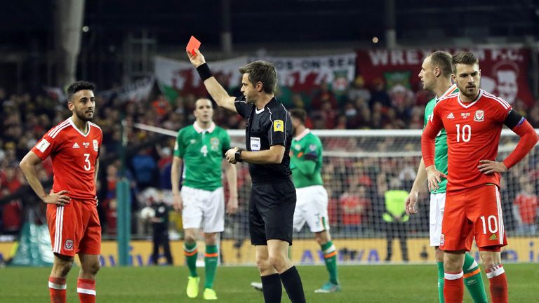 Neil Taylor is shown a red card by referee Nicola Rizzoli for his tackle on Seamus Coleman