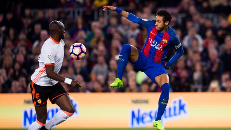 Neymar of Barcelona controls the ball next to Eliaquim Mangala (L) of Valencia CF during the La Liga match at the Nou Camp