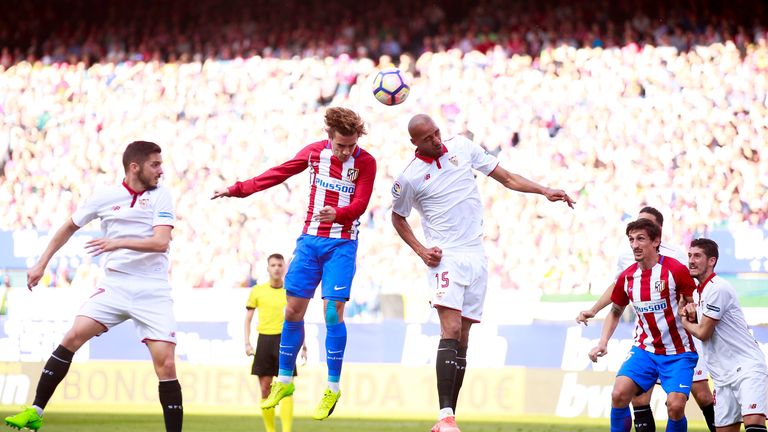 Griezmann (left) wins the header before Steven N'Zonzi