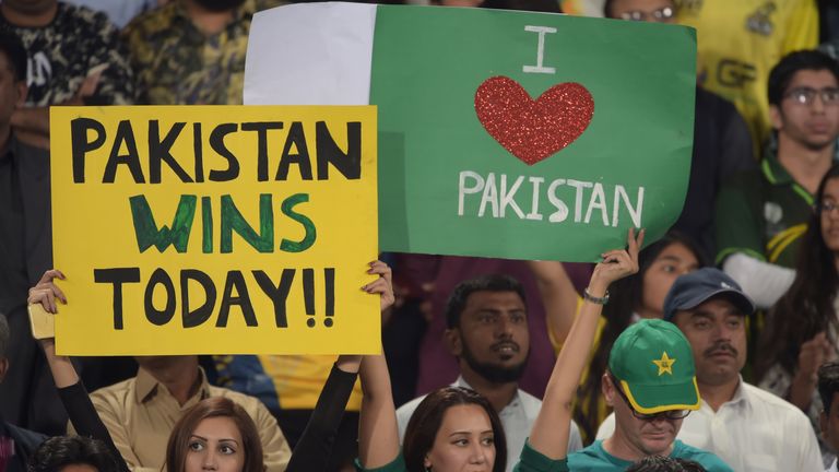Pakistani spectators hold placards prior to the start of the final of the Pakistan Super League (PSL) between Quetta Gladiators and Peshawar Zalmi