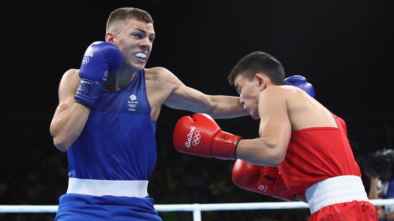 RIO DE JANEIRO, BRAZIL - AUGUST 11:  Abialkhan Zhussupov of Kazikstan (red) fights Pat McCormack of Great Britain (blue) in their Mens Light Welterweight b