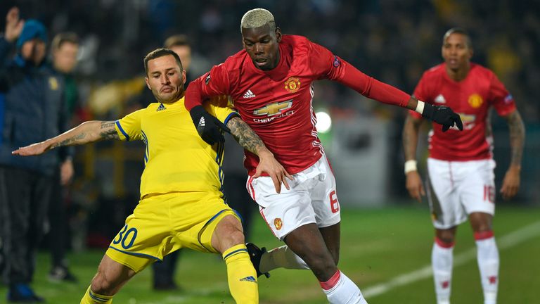 Manchester United's French midfielder Paul Pogba (R) fights for the ball with Rostov's defender Fedor Kudryashov (L) during the UEFA Europa League round of