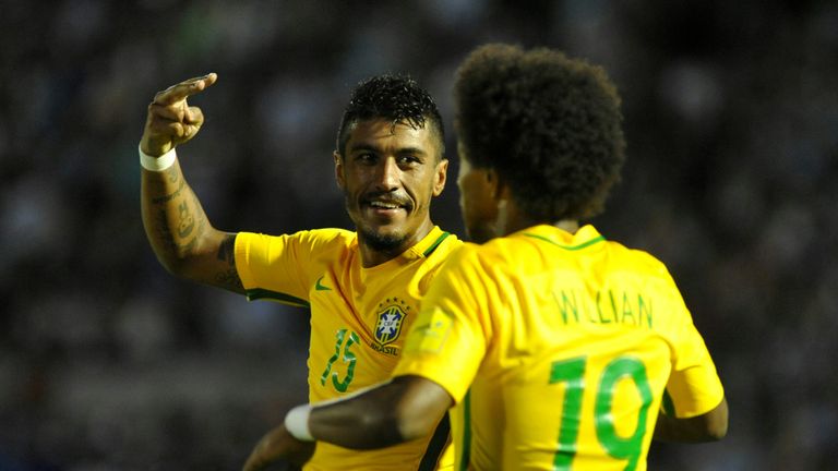 Brazil's midfielder Paulinho (L) celebrates with teammate Brazil's midfielder Willian his second goal during their 2018 FIFA World Cup qualifier football m