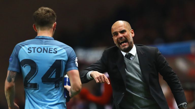 Manchester City manager gives instructions to John Stones during the match against Monaco