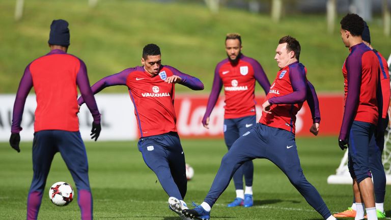 BURTON-UPON-TRENT, ENGLAND - MARCH 21: Chris Smalling of England tackles Phil Jones of England in training