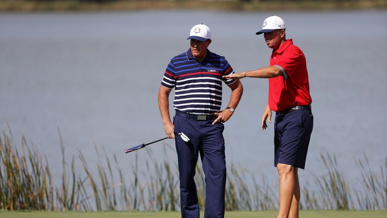 CHASKA, MN - SEPTEMBER 29: Phil Mickelson of the United States discusses a putt with caddie Jim Mackay during practice prior to the 2016 Ryder Cup at Hazel