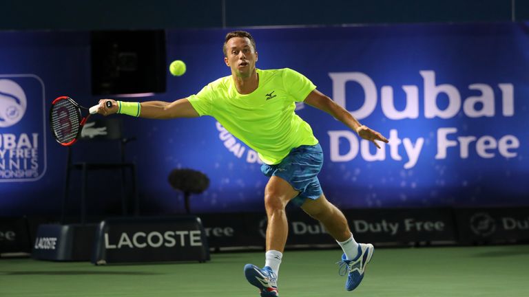 Philipp Kohlschreiber of Germany returns the ball to Andy Murray of Great Britain during their ATP quarter-final tennis match as part of the Dubai Duty Fre