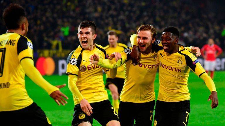 Pierre-Emerick Aubameyang (left) is congratulated by his Dortmund team-mates after scoring to make it 3-0