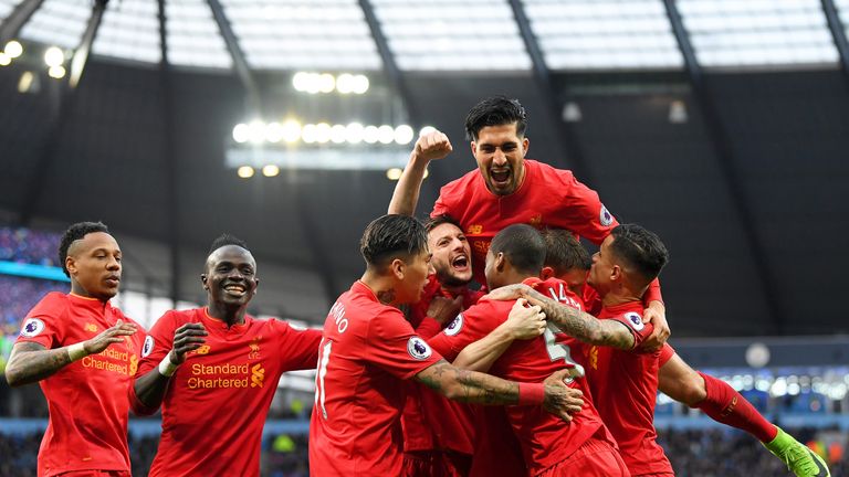 James Milner is surrounded by his Liverpool team-mates after scoring from the penalty spot