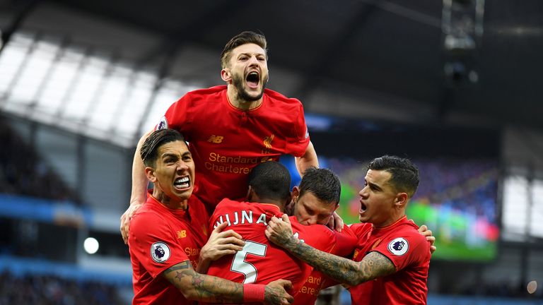 James Milner (C) celebrates with team-mates after giving Liverpool a 1-0 lead