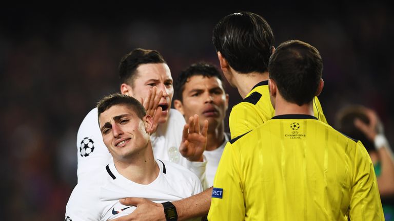 Marco Verratti and Julian Draxler appeal to referee Deniz Aytekin after Barcelona are awarded a penalty