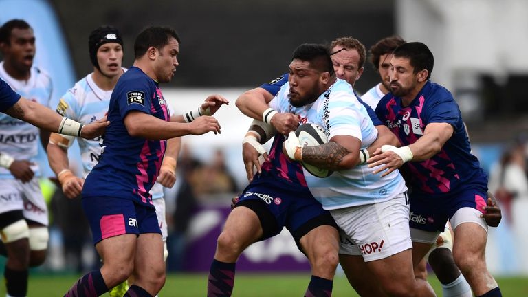 Racing-Metro's New-Zealander prop Benjamin Tameifuna (2nd R) is tackled by Stade Francais' players during the French Top 14 rugby union match between Racin