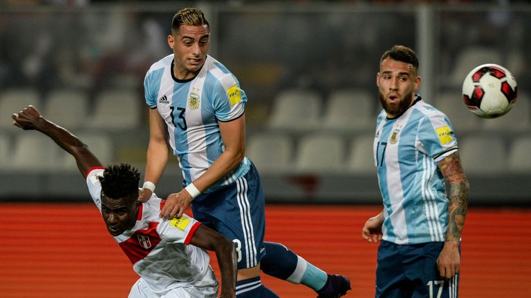 Argentina's Ramiro Funes Mori (2-L) vies for the ball with Peru's Christian Ramos (L) next to Argentina's Nicolas Otamendi during their Russia 2018 World C