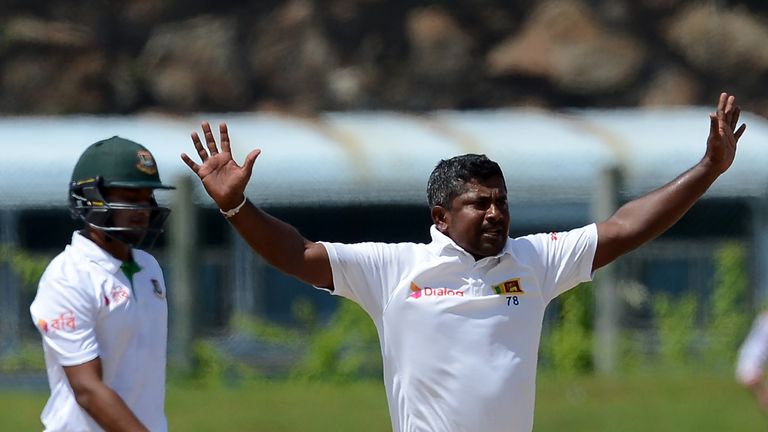 Sri Lankan cricket captain Rangana Herath (R) celebrates after he dismissed Bangladesh cricketer Shakib Al Hasan during the final day of the opening Test m