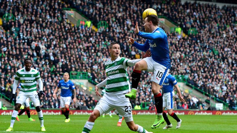 Rangers' Barrie McKay of Rangers (right) wins a header over Celtic defender Mikael Lustig