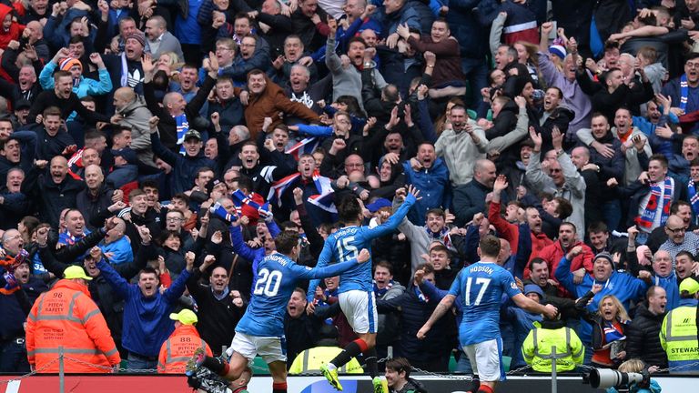 Rangers players celebrate in front of their fans at Celtic Park after Hill's late equaliser