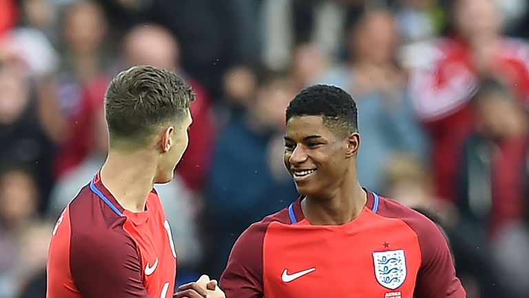 England's striker Marcus Rashford (R) celebrates after scoring his team's first goal during the International friendly football match between England and A