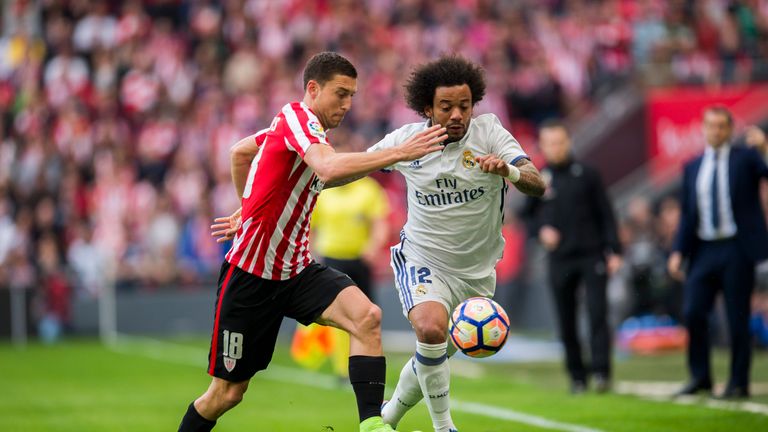 Real defender Marcelo competes for the ball with Bilbao's Oscar De Marcos