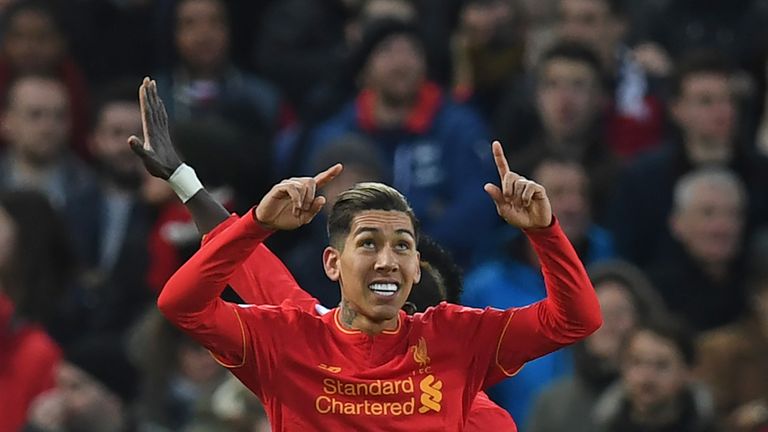 Roberto Firmino celebrates after scoring the opening goal of the Premier League football match between Liverpool and Arsenal at Anfield
