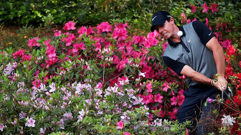 AUGUSTA, GA - APRIL 11:   (Editors Note: This is a retransmission of #484233507) Rory McIlroy of Northern Ireland hits a shot out of the the azalea bushes 