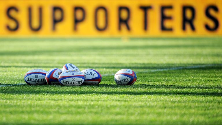 Rugby balls are pictured on the field prior to a French Top 14 rugby union match at the Stade des Alpes