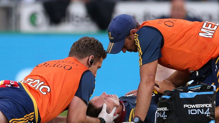 Ben Smith receives medical attention after contesting a high ball against the Chiefs