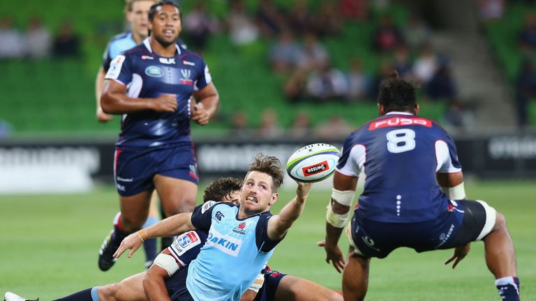 Bernard Foley is tackled by Tom English of the Rebels