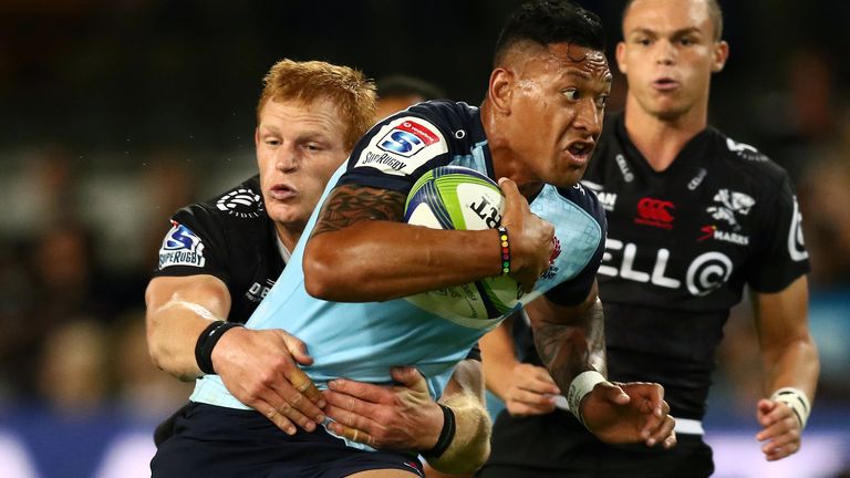 Israel Folau is tackled by Philip Van der Walt of the Sharks