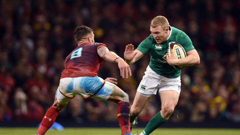 Keith Earls attempts to fend off Wales scrum-half Rhys Webb