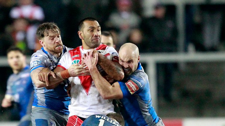 Zeb Taia tackled by Wakefield's Danny Kirmond and Liam Finn