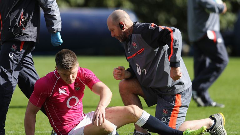 Owen Farrell gets to his feet after receiving attention from  England physio Phil Pask