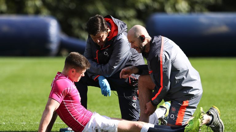 Owen Farrell is given treatment during an England Media Session at Pennyhill Park