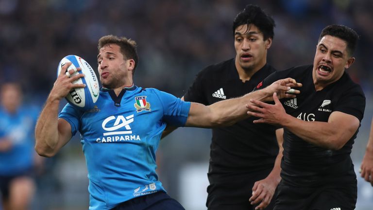 Tommaso Benvenuti is tackled by Anton Lienert-Brown of the All Blacks