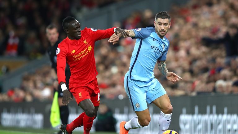 LIVERPOOL, ENGLAND - DECEMBER 31:  Sadio Mane of Liverpool and Aleksander Kolorov of Manchester City clash during the Premier League match between Liverpoo